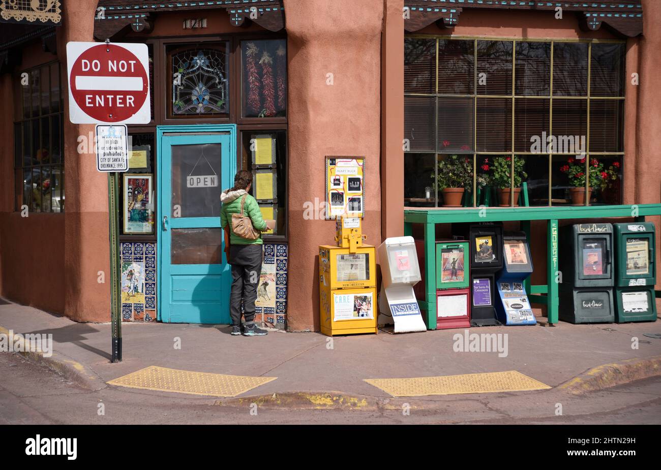 A Woman Reads The Lunch Menu Posted At The Entrance To A Popular